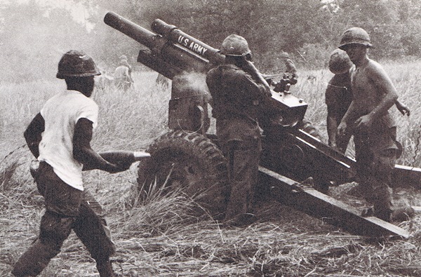 Vietnam War - First Infantry Division.  U.S. Army 2nd Battalion, 33rd  Field Artillery soldiers operate a 105 mm howitzer during a fire mission. Courtesy of First Infantry Division