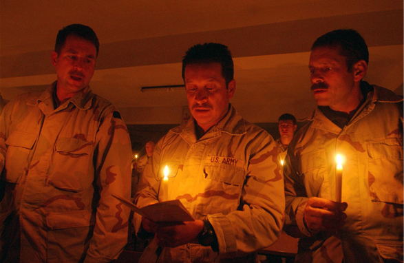 Soldiers pray during a candlelight prayer service in Mazar-e Sharif, Afghanistan, in celebration of Christmas