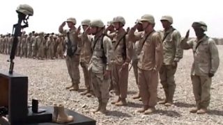 42nd Infantry Division in Iraq 2004-05 Soldiers of the 42nd Infantry Division, New York National Guard, pay respects to a fallen comrade at a memorial service in Iraq.