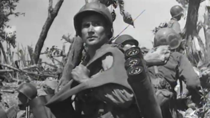 World War II soldier carrying a large load of equipment